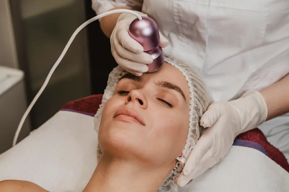 Radiofrequency skin tightening treatment being applied to a patient's face, aiming to tighten skin and stimulate collagen production for rejuvenation
